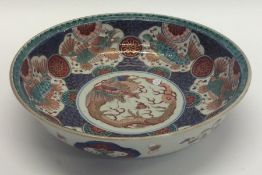 A decorative Chinese bowl inset with dragons and g