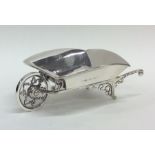 A novelty miniature silver wheelbarrow with scroll