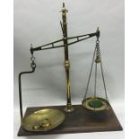 A pair of large heavy brass mounted kitchen scales