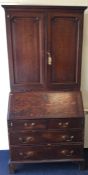 A Georgian oak bureau / bookcase on bracket feet t