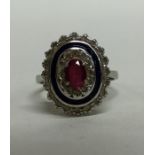 A ruby and enamelled cluster ring in 18 carat gold