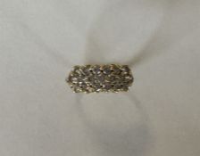 An 18 carat gold diamond three row ring. Approx. 4