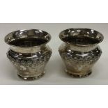 A pair of silver mounted candle holders decorated