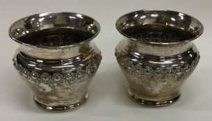 A pair of silver mounted candle holders decorated