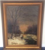 A large gilt framed oil on canvas depicting stags