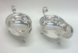 A good pair of Edwardian silver sauce boats with b