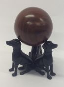 A novelty cast model of three dogs in seated posit