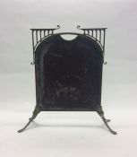 A brass and plate glass fire screen on splayed sup