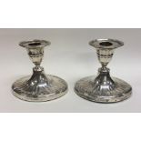 A pair of oval Edwardian silver half fluted candle