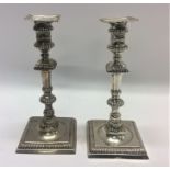 A good pair of George II cast silver candlesticks