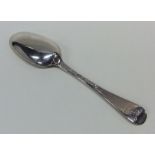 A Georgian silver dessert spoon with crested termi