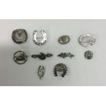 A bag containing silver and other brooches. Est. £