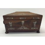 A rosewood and MOP tea caddy with fitted interior.