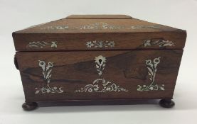 A rosewood and MOP tea caddy with fitted interior.