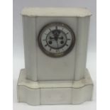 A large white marble mantle clock with striking mo