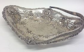 A heavy silver swing handled basket embossed with