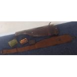 An old leather gun case together with a canvas exa