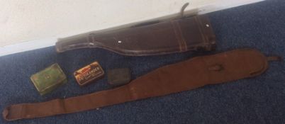 An old leather gun case together with a canvas exa