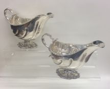 A pair of Georgian style silver sauce boats with g