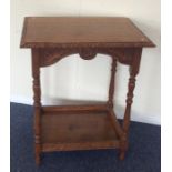 An oak carved occasional table. Est. £20 - £30.