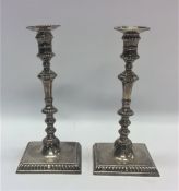 A good pair of George II cast silver candlesticks