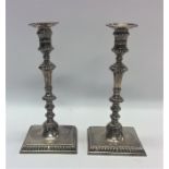 A good pair of George II cast silver candlesticks