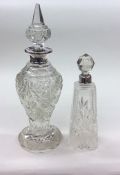 A tall glass and silver mounted scent bottle and s