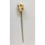 An Antique ivory mounted stick pin in the