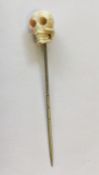 An Antique ivory mounted stick pin in the