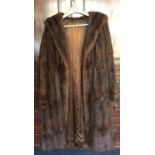 An old fur coat with silk lining. Est. £25 - £35.