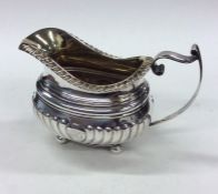 A Georgian half fluted silver cream jug. Exeter. B