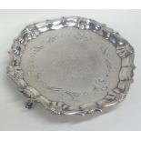 A Georgian silver waiter attractively engraved wit