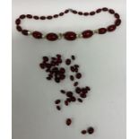 A bag containing graduated amber beads. Approx. 98
