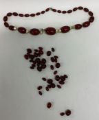 A bag containing graduated amber beads. Approx. 98