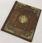 A 19th Century wooden book cover with brass onlays