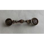 An unusual silver brooch inset with coins. Approx.