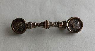 An unusual silver brooch inset with coins. Approx.