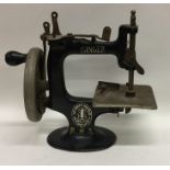A miniature travelling Singer sewing machine. Est.