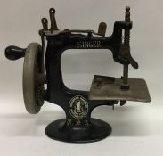 A miniature travelling Singer sewing machine. Est.