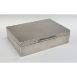 A rectangular engine turned silver cigarette box w