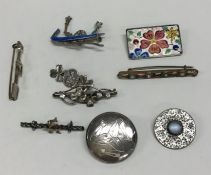 A bag containing silver and other brooches. Est. £