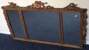 A good gilt triple mirror with scroll decoration.
