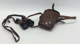 A pair of leather mounted Military binoculars. Est