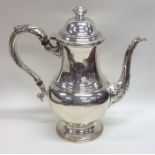 A baluster shaped silver water jug on scroll pedes
