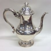 A baluster shaped silver water jug on scroll pedes