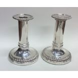 A good pair of circular Georgian silver candlestic