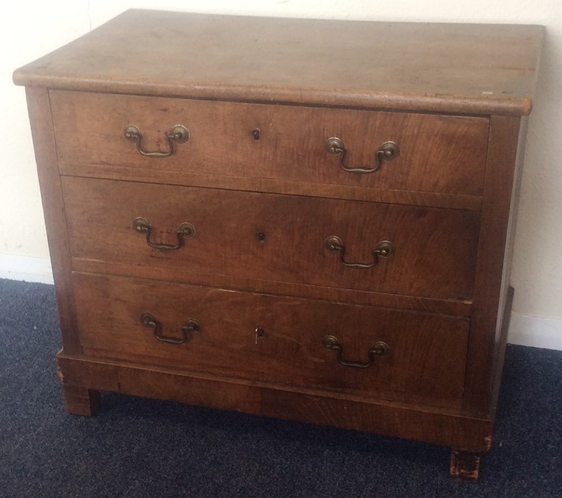 A bachelor's chest of three drawers with brass han