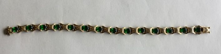 A silver gilt green stone bracelet with concealed