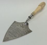 A silver mounted and ivory trowel engraved with fl