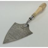 A silver mounted and ivory trowel engraved with fl